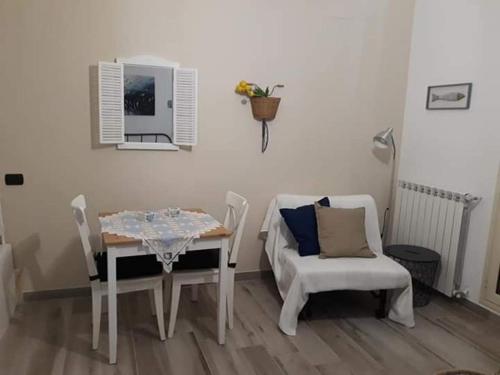 a dining room with a table and a chair at La Casetta di Laura in Cefalù