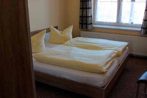 ヴェルニゲローデにあるFerienwohnung 8のベッド(白いシーツ、枕付)