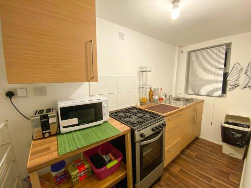a kitchen with a microwave and a stove top oven at Preston Stanley 1 Bed Flat 3a in Preston