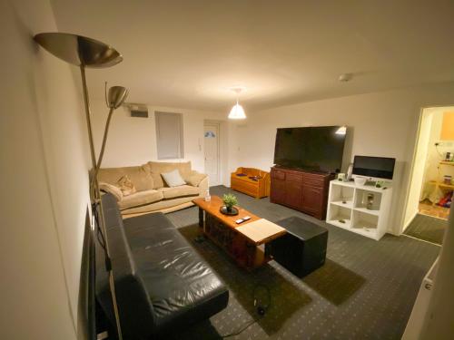 a living room with a couch and a tv at Preston Stanley 1 Bed Flat 3a in Preston