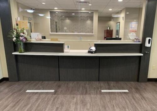 a lobby with a reception counter with flowers on it at Candlewood Suites - Austin North by IHG in Austin