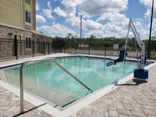 a swimming pool with a swing in a building at Woodspring Suites Orlando International Drive in Orlando