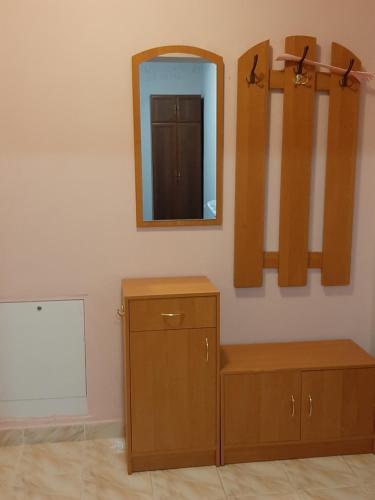 a room with a mirror and a wooden cabinet at Apartment on Lermontova 35a in Mukacheve