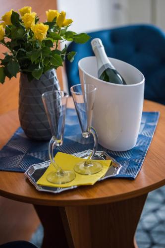 a table with two glasses and a bottle of wine at Hotel Viktória in Sárvár