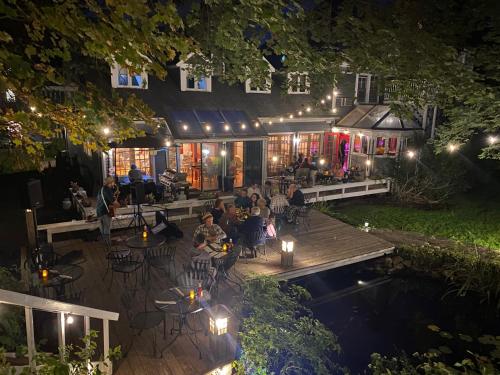 a group of people sitting on a deck at night at The Cornell Inn, Lenox & The Berkshires in Lenox
