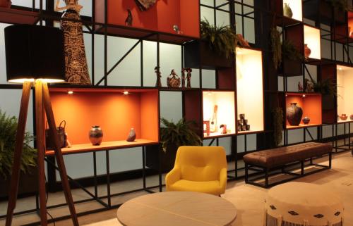 a lobby with a yellow chair and vases on display at Hotel Fontan Reforma Centro Historico in Mexico City