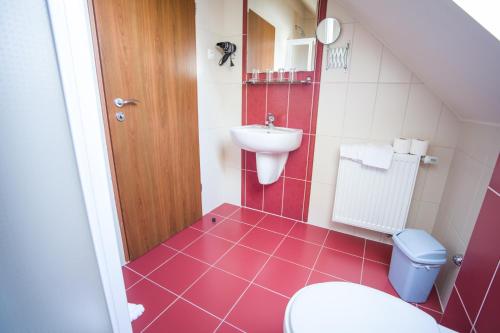 a bathroom with a toilet and a sink at Hotel Viktória in Sárvár