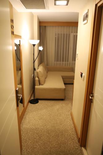 a bedroom with a bed and a lamp in a room at Trakya City Hotel in Edirne