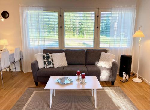 a living room with a couch and a coffee table at Cozy renovated house with a lot of parking space. in Haparanda