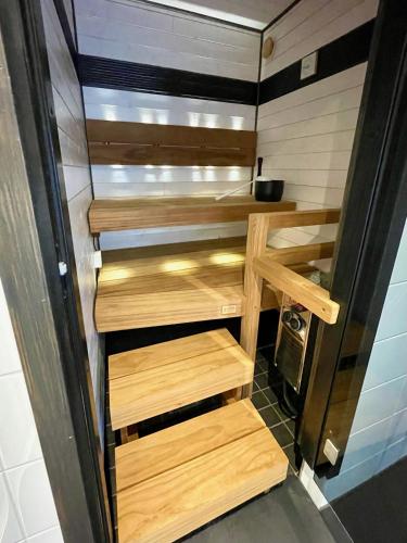 a small kitchen with wooden stairs in a trailer at Cozy renovated house with a lot of parking space. in Haparanda