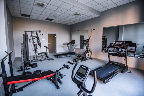 a gym with several exercise equipment in a room at Hotel Park Shtip in Štip