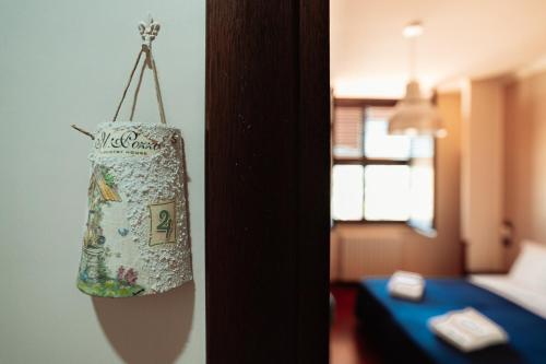 a bag hanging from a wall in a hotel room at Il Pozzo Country House in Collescipoli