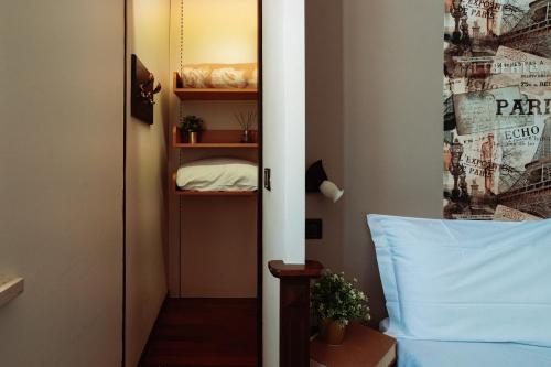 a bedroom with a door open to a room with a bed at Il Pozzo Country House in Collescipoli