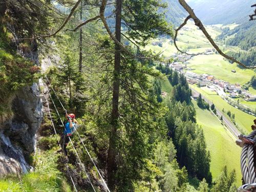 a group of people on a zip line in the mountains at Ferienwohnung Eller 79 in Vals