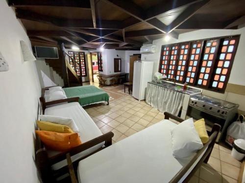 a room with two beds and a kitchen with a stove at ReservAmazon Forest Hotel in Belém