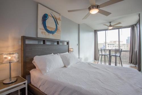 a bedroom with a bed and a window with chairs at 804 Free Parking Modern Downtown Apt, Great Wifi in Atlanta
