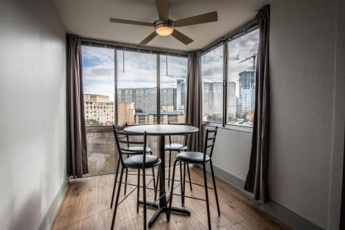 a table and chairs in a room with a large window at 804 Walk to World Cup 2026, MBS, DT ATL, Parking in Atlanta
