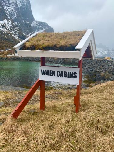 a sign that saysvalen gatsgins on a field at Valen Cabins in Reine in Reine