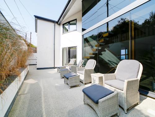 a group of chairs sitting on a patio at Megizzy in Polzeath