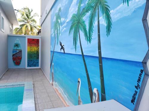 a mural of the ocean and palm trees in a hallway at Palmeras Del Mar in Isabela