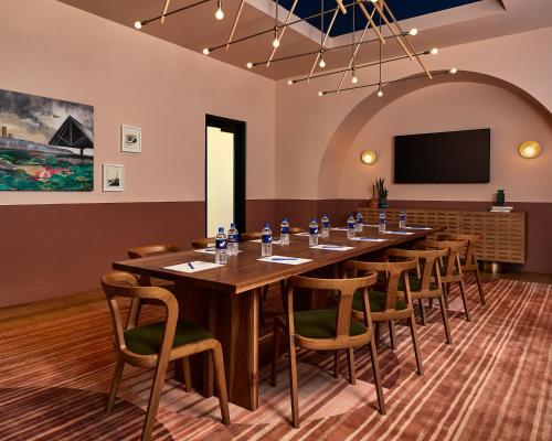 a large conference room with a long table and chairs at Catbird Hotel in Denver