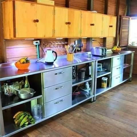 a kitchen with a counter top with lots of appliances at playa mecana kirita in Bahía Solano