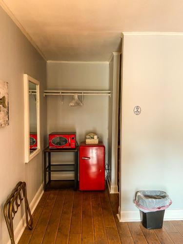 a kitchen with a red refrigerator and a microwave at Reel Inn and Lodge in Quitman