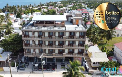 a building with a hotel sign in front of it at Coral View Hotel & Resort in Caye Caulker