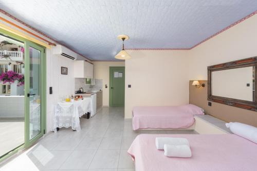 a large room with two beds and a kitchen at Room in Studio - Senior Citizen Suite in blue in Hersonissos