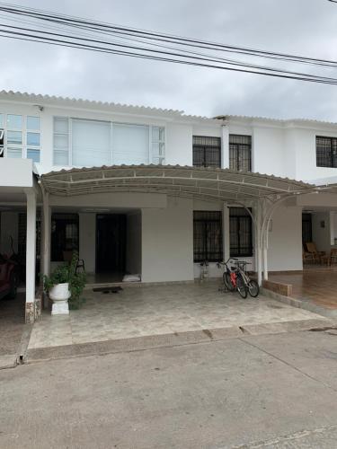 a large white house with a large patio at Hostal Lucy in Valledupar