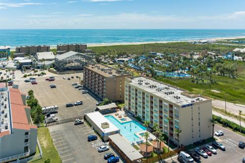an aerial view of a resort with a pool and the ocean at Charming 1 Bedroom, 3 Minute Walk To The Beach Condo in South Padre Island
