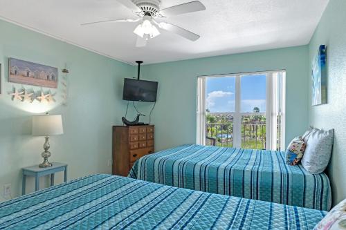 a bedroom with two beds and a window at Charming 1 Bedroom, 3 Minute Walk To The Beach Condo in South Padre Island