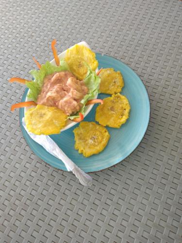 a blue plate of food on a table at posada donde Uriel Playa tranquila in Baru