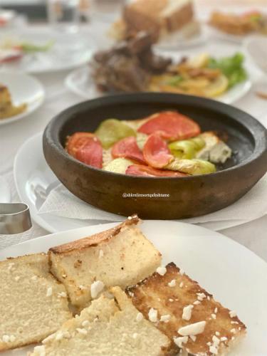 a table with a pan of food on a plate at Shkreli Resort Qafeshtame in Krujë