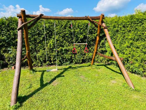 an empty swing set in a field of grass at Penzion Kelčany u Kyjova in Kelčany