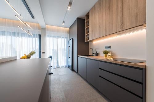 a kitchen with wooden cabinets and a counter top at Villa Aria in Novalja