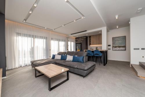 a living room with a couch and a table at Villa Aria in Novalja