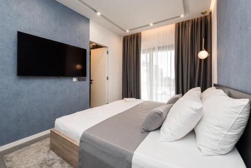 a bedroom with a large bed with white pillows at Villa Aria in Novalja