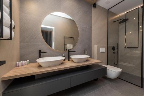 a bathroom with two sinks and a mirror at Villa Aria in Novalja