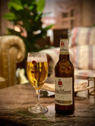 a bottle of beer and a glass on a table at Querfurter Hof in Querfurt