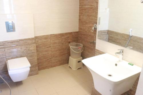 a bathroom with a toilet and a sink at Hotel Starline in Guwahati