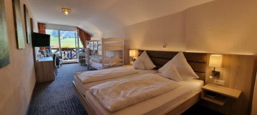 a hotel room with a bed and a television at Hotel Magdalenenhof inklusive MeineCardPlus in Willingen