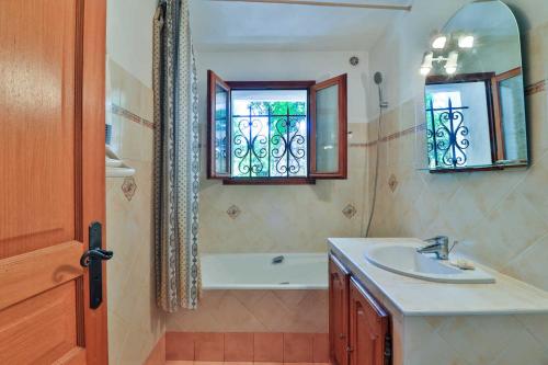 a bathroom with a sink and a tub and a window at La Pascaline Registered Accomodation 4 , Gites in France , Recommended By l in Le Bar-sur-Loup