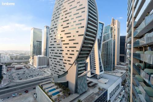 a tall building in the middle of a city at bnbmehomes - Merano Tower in Dubai