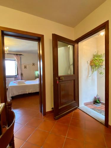 a room with a door leading to a bedroom at La Magione dei Todaro in Borgo a Buggiano