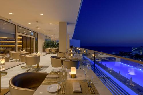 a restaurant with a view of the ocean at night at Amarande (Adults Only) in Ayia Napa