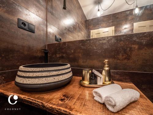a bathroom with a bowl sink on a wooden table at JUMBO APARTMENTS in Rajecké Teplice