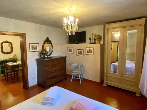 a bedroom with a bed and a dresser and a mirror at La Magione dei Todaro in Borgo a Buggiano