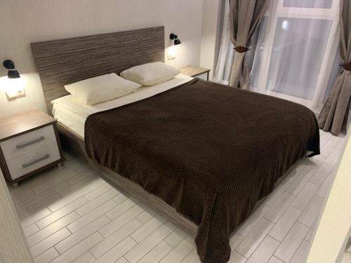 ヴォルゴグラードにあるVIP Art House Volgograd Arenaのベッドルーム1室(ブラウンの毛布を使用した大型ベッド1台付)