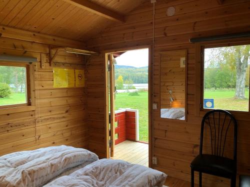 a room with two beds in a log cabin at 2 persoons stuga in Hammarstrand
